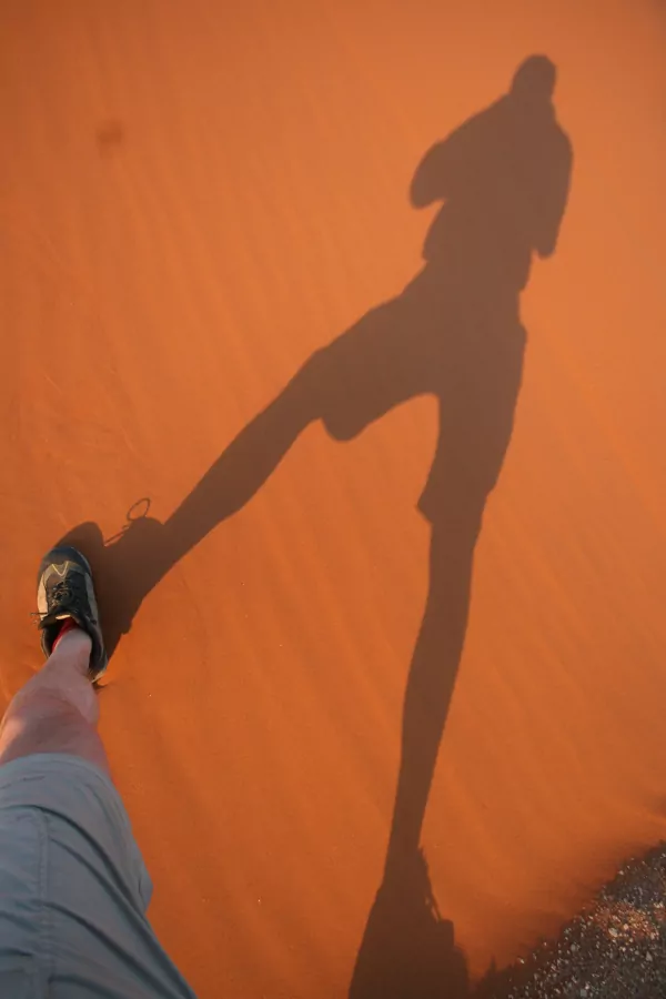 Namibia Schatten-Fotograf auf rotem Sand